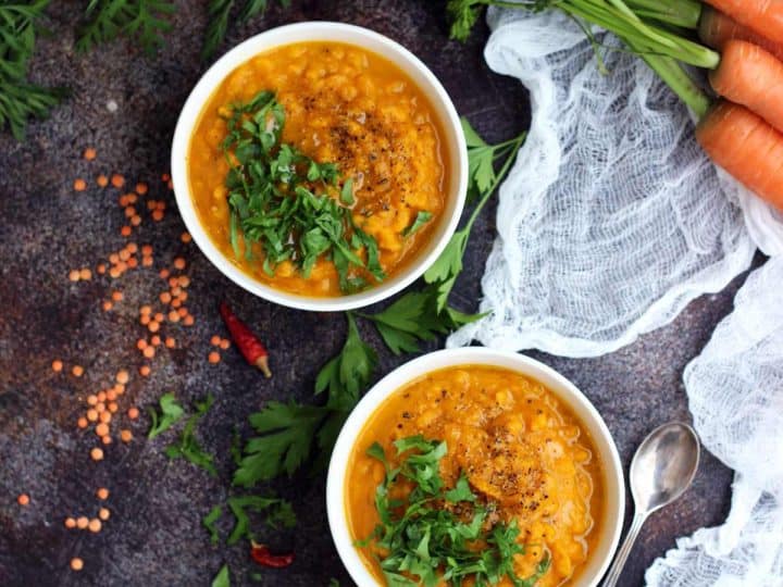 Vegan Roasted Carrot Soup with Lentils in Bowls Garnished with Parsley